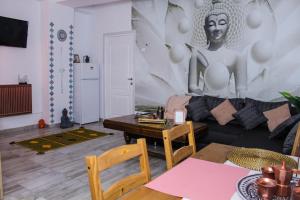 a living room with a black couch and a table at Nirvana Apartament in Bucharest +11 photos