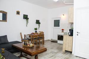 a living room with a table and a kitchen at Nirvana Apartament in Bucharest
