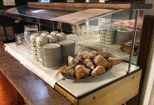 a table with a plate of pastries on a counter at Hotel Europa in Pozza di Fassa