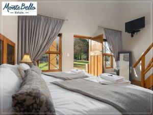three beds in a room with a tv on the wall at Mont d'Or Monte Bello Estate in Bloemfontein