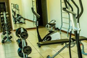 a gym with several exercise bikes and tread machines at Hotel Fazenda Da Chácara in Santana dos Montes
