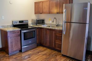 a kitchen with a refrigerator, stove, sink and microwave at Aspen Village in Waterton Park