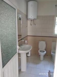 a bathroom with a sink and a toilet at Casa Prifti in Vlorë