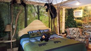 a bedroom with a bed with a stuffed bear on it at Bear Cove Inn in Saint Ignace