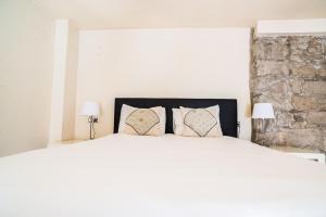 Posteľ alebo postele v izbe v ubytovaní Urbi Apartments