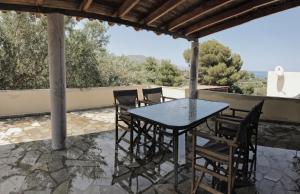 a table and chairs on a patio with a view at Villa Gaia in Monemvasia