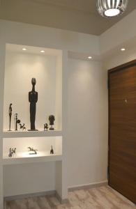 a room with a shelf with sculptures on it at Athens historical center Love suite 2 in Athens