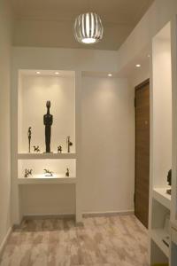 a room with a shelf with a statue on it at Athens historical center Love suite 2 in Athens +28 photos