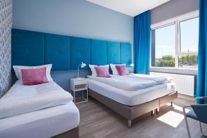 Llit o llits en una habitació de ODDSSON Hotel