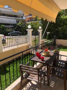 a table and chairs on a balcony with an umbrella at Artemis Apartments in Lefkada +4 photos