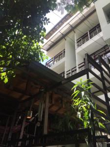 a building with awnings and trees in front of it at Casa Kiwi Hostel in Medellín