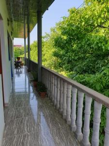 a balcony with a white railing and trees at Tatev Shinuhayr Hotel' in Shinuhayr