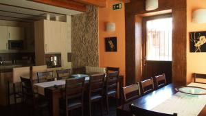 a dining room with tables and chairs and a window at Los Barruecos in Pinilla de los Barruecos