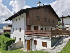 a large white building with a wooden roof at La Roncolina in Cortina dʼAmpezzo