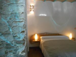 a bedroom with a bed and a lamp at XARDÍN DE ESTRELAS *** in Sarria