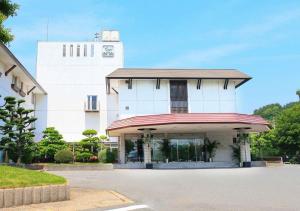 a white building with a clock tower in the background at Kurashiki - Hotel / Vacation STAY 31267 in Kurashiki