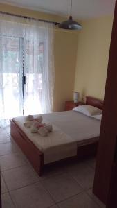 a bedroom with a large bed with towels on it at Dimitris & Vassiliki's apartment in Possidi