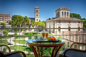 a table with a plate of fruit on a balcony at Hotel Jollino in Pineto
