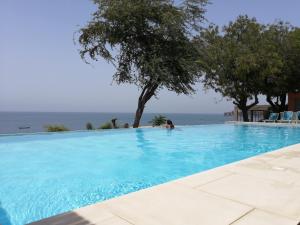 a swimming pool with a view of the ocean at Union Amicale Corse Dakar in Dakar