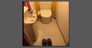 a bathroom with a toilet and a sink and a pair of shoes at Tanabe - Hotel / Vacation STAY 15383 in Tanabe