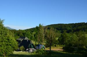 a house in the middle of a field with trees at Natura Plitvice Lakes in Plitvička Jezera