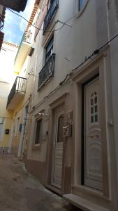 a building with a door on the side of it at Casa Bonequinha in Nazaré