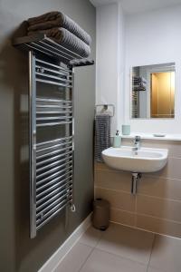 a bathroom with a sink and a mirror at Modern One Bedroom Apartment in Cardiff Bay in Cardiff