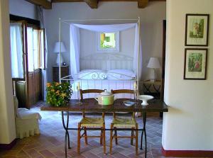 a bedroom with a table and a bed with a canopy at Le Traverse in Pienza