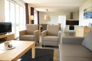 a living room with a couch and chairs and a tv at Resort Winterberg, Winterberg-Neuastenberg in Winterberg