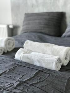 łóżko z 3 białymi ręcznikami w obiekcie Nowa Motława Studio 31 SPA w Gdańsku