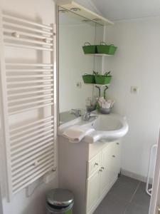 a white bathroom with a sink and a mirror at Suite privée près d'Uzès in Pougnadoresse +3 photos