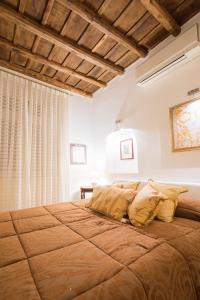 a bedroom with a large bed in a room at Portico D'ottavia in Rome