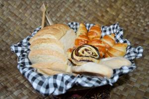 a basket of bread and pastries on a table at Pondok Masa Depan in Sidemen