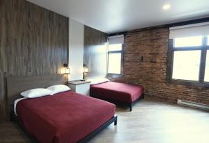 Postel nebo postele na pokoji v ubytování Crosby Lofts