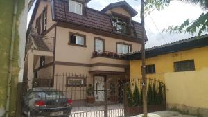 a house with a car parked in front of it at Emma Apartments in Bitola