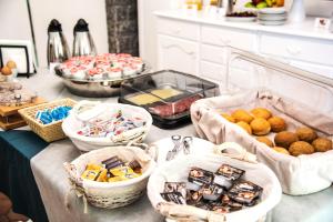 a table topped with baskets of food and desserts at Ischia Dream Sunset in Ischia