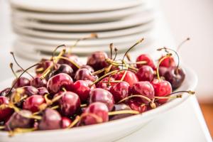 a bowl of cherries sitting on top of a plate at Ischia Dream Sunset in Ischia