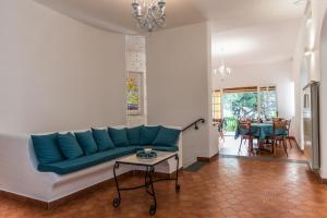 a living room with a blue couch and a table at Ischia Dream Sunset in Ischia