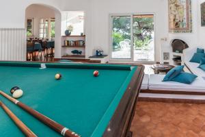 a pool table in the middle of a living room at Ischia Dream Sunset in Ischia