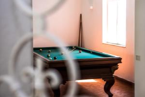 a pool table in a room with a window at Ischia Dream Sunset in Ischia