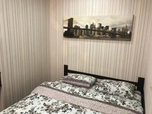 a bedroom with a bed and a picture on the wall at Comfort Arenda.Minsk 2 in Minsk