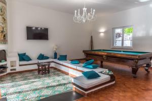 a living room with a pool table and a couch at Ischia Dream Sunset in Ischia