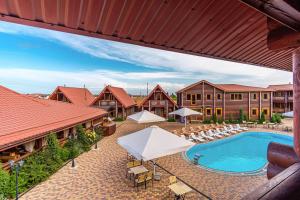 an image of a pool at a resort with chairs and a building at AKVALIS комплекс для отдыха in Odesa