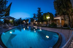 a swimming pool at night with lights at Ischia Dream Sunset in Ischia