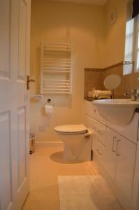 a bathroom with a white toilet and a sink at 19 Upper Linney in Ludlow +13 photos