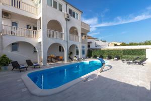 a swimming pool in front of a building at Villa Anja in Split