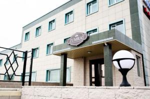 a building with a street light in front of it at Hotel Zumrat in Karagandy