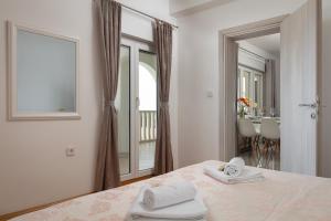 a bedroom with a bed with two towels on it at Villa Anja in Split +49 photos
