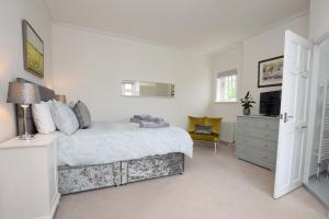 a bedroom with a bed and a dresser and a television at B&B@no2 in Sheringham