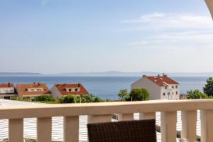 a balcony with a view of the ocean and houses at Villa Anja in Split